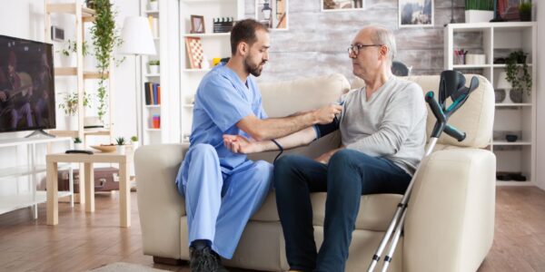 caucasian-young-doctor-nursing-home-checking-blood-pressure-elderly-age-male-with-crutches New Alamo Residence Home in Alamo
